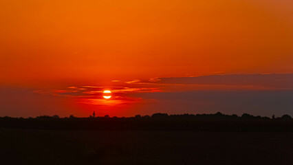 Summer sunset with a church silhouette near Buchhofen, Deggendorf, Bavaria, Germany
