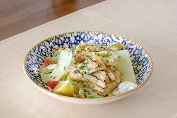 Grilled chicken salad with lettuce parmesan lemon and tomato