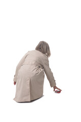 back view of a woman picking up a cigarette pack on the floor on white background