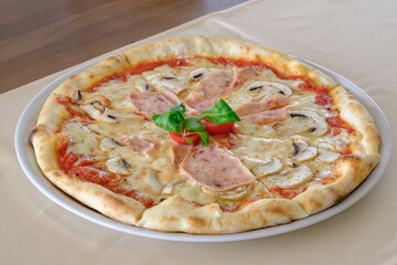 A delicious pizza topped with melted cheese savory ham and earthy mushrooms