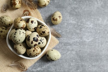 Quail eggs in a plate on gray background 