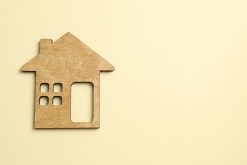 Wooden house on color background