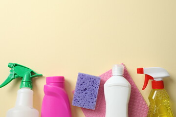 Many different cleaning products on color background, top view