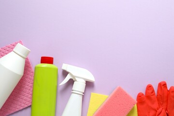 Many different cleaning products on color background, top view