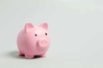 Piggy coin bank on gray background for money savings, financial security or personal funds concept.