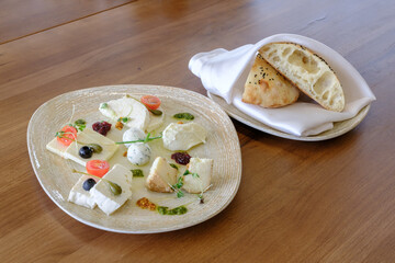 A plate of assorted cheeses and a side of flatbread The perfect appetizer!