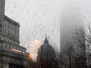 The raindrops on the window with downtown skyscrapers in the background. Montreal, Quebec, Canada