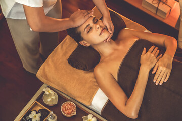 Caucasian woman enjoying relaxing anti-stress head massage and pampering facial beauty skin...