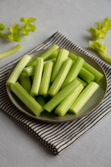 Raw Organic Celery Sticks on a Plate, side view.