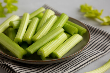 Raw Organic Celery Sticks on a Plate, side view.