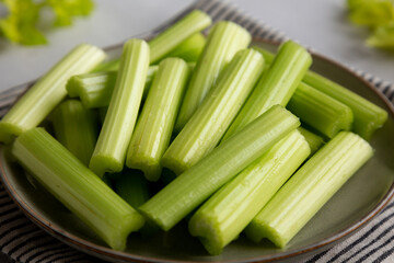 Raw Organic Celery Sticks on a Plate, side view.