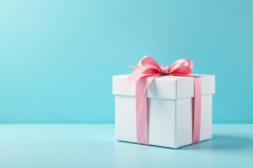 Obraz premium White gift box with ribbon on blue sky background, paper, wrapping