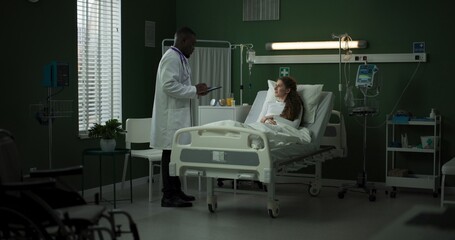 Doctor enters the room with a tablet, ready to review the patient's progress.