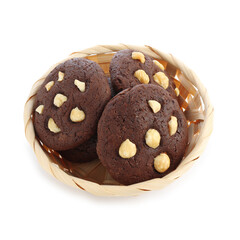 Tasty chocolate cookies with hazelnuts in wicker basket isolated on white