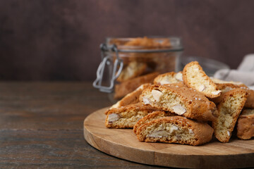 Traditional Italian almond biscuits (Cantucci) on wooden table, closeup. Space for text