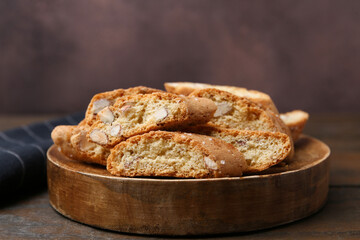 Tasty almond biscuits (Cantuccini) on wooden table, closeup