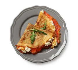 Delicious crepes with salmon, cream cheese and arugula isolated on white, top view