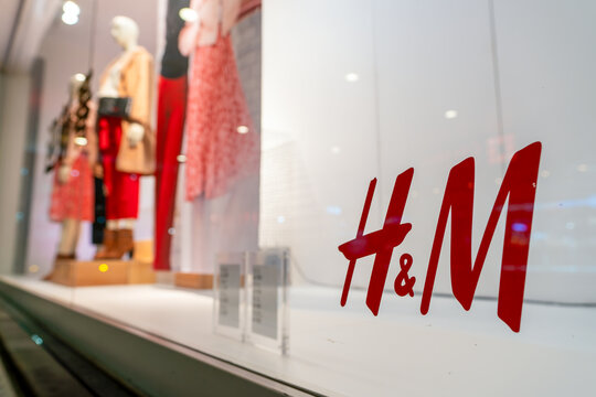 Shenzhen, China - January 17, 2019: a close-up shot of the H and M sign as seen on the store window glass. H and M is a global clothing retail chain selling fashion apparel and accessories.