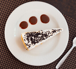 Delicious slice of banoffee pie topped with whipped cream and chocolate sprinkles, perfect for dessert