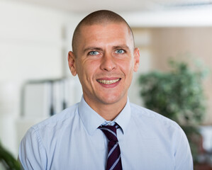 Portrait of businessman who is at his work place in office