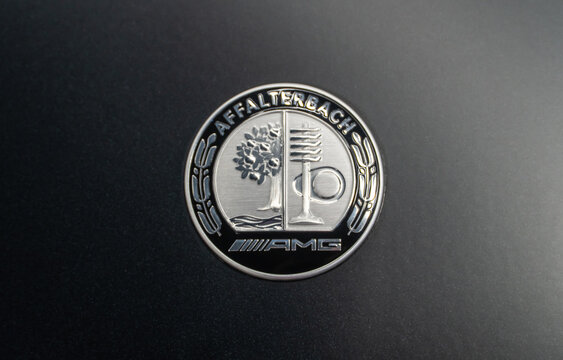 AMG Affalterbach logo on a gray matte background, close-up. AMG Affalterbach nameplate on the hood of the luxury Mercedes-Benz S63 S-class W223 V8 biturbo. 