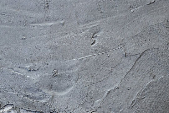 Cementation of a garden path.Texture of cement surface with irregularities.Spring work in the garden.