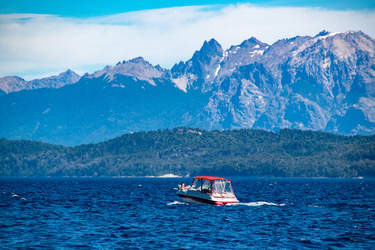Boat crossing waters of nahuel huapi national lake, bariloche,  argentina.