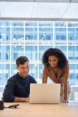 Two diverse employees professionals discussing financial data at corporate business meeting. Busy...
