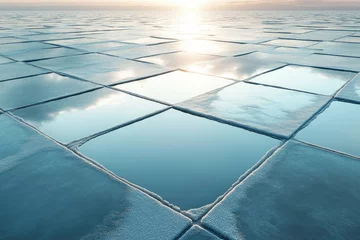 Frozen salt pans reflect the sky, creating a stunning geometric pattern at sunrise. © stockphoto02