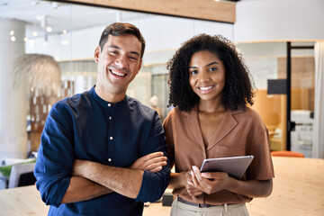 Two young diverse confident business man and woman, happy creative international professional...