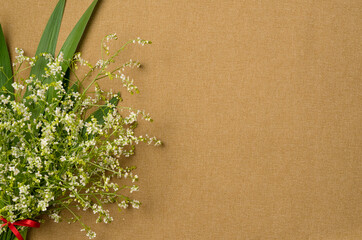 Bouquet of flowers on fabric background. Flat lay, top view. Copy space