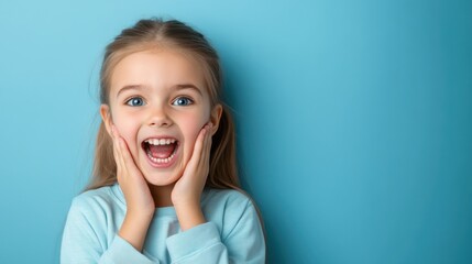 Joyful young girl expresses happiness with bright eyes and cheerful smile against a vibrant blue background