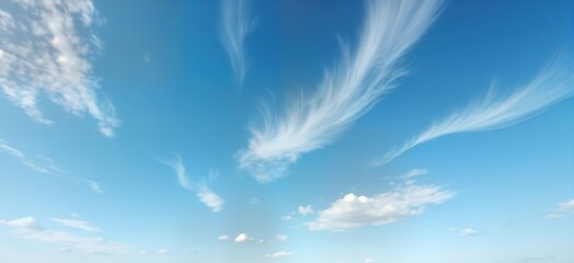 Fluffy white clouds float in vivid blue sky. Beautiful cloudscape. Light, bright day. Natural scenery. Summer day. High in atmosphere. Natural light. Colorful bright colors. Heavenly panorama.