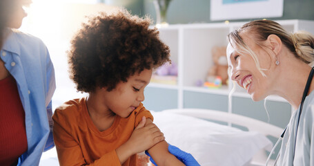 Doctor, child and smile for injection, vaccination and hospital support for health examination. Pediatrician, medical expert and boy for consultation, immunization and flu shot healthcare appointment © peopleimages.com