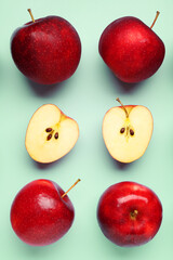 Fresh ripe red apples on light blue background, flat lay