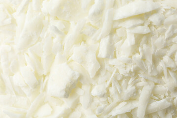White soy wax flakes as background, closeup