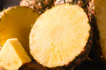 Slices of ripe pineapple on table, closeup