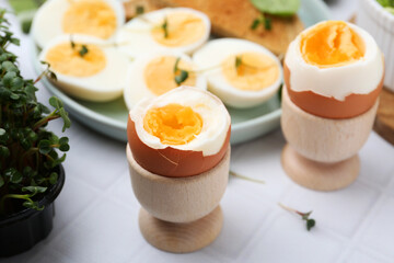 Many boiled eggs on white tiled table, selective focus