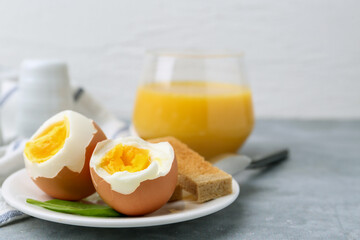Soft boiled eggs with bread on grey table, closeup. Space for text