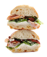 Delicious sandwiches with prosciutto and sun dried tomatoes isolated on white
