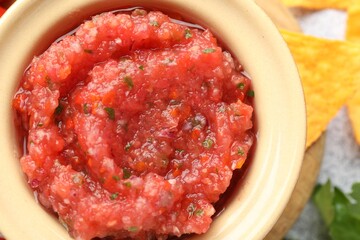 Spicy salsa sauce in bowl on table, top view
