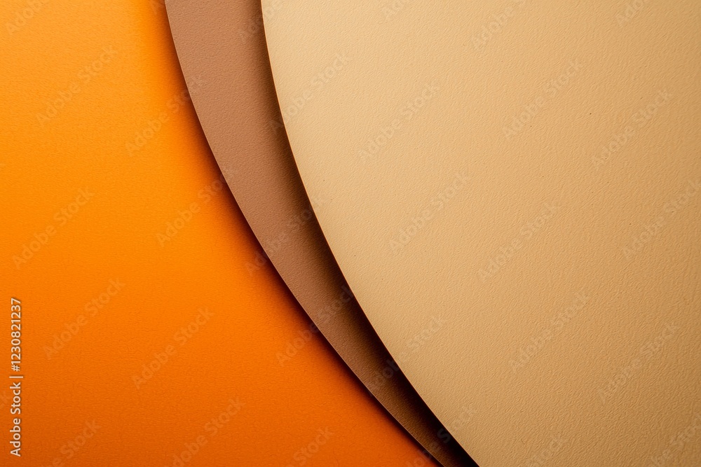 Poster sheets of orange, brown, and beige paper are overlapping, creating a visually appealing abstract com