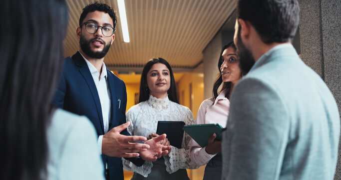 Discussion, project or business people in lobby for feedback or schedule update in conference hall. Teamwork, employees or keynote speaker with staff in office for networking, seminar or event review