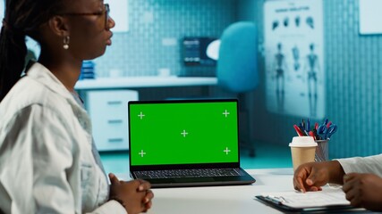 Health care professional engages in conversation with patient next to isolated display, combining medical expertise with support to ensure wellness. Physician discuss with young girl. Camera A.