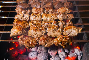 Pork and beef meat is fried on Mangal (barbecue). Cooking food on hot coals and metal skewers