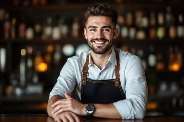 Obraz premium portrait of a young smiling Argentine male bartender against blurred bar background