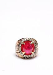 Close up of a red agate ring isolated on a white background.Ring with sparkling diamond decoration.Men's hobbies and accessories concept.Copy space for text.For graphic design or banner background