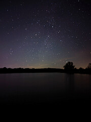 Starry Night Sky Over a Calm Lake