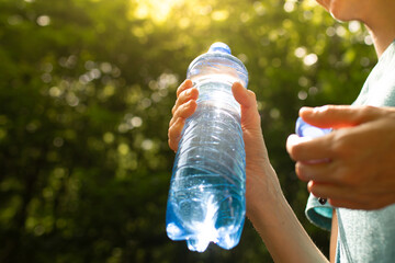 Person holding bottle of water, drink water, diet and health concept 