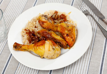 Appetizing pieces of fried chicken with rice on platter